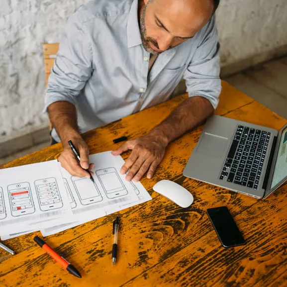 A man at a table designing software