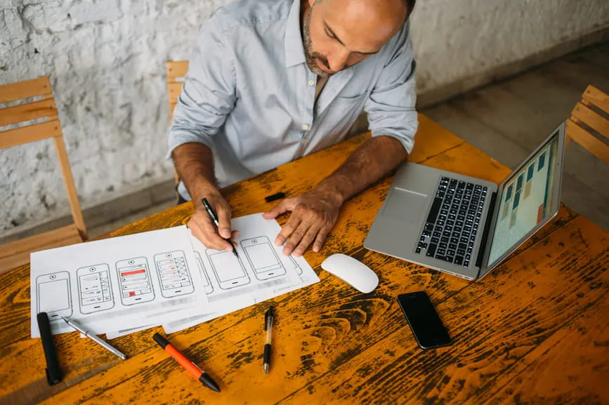 A man at a table designing software